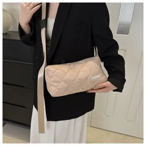 Detail of beige quilted nylon crossbody bag featuring stylish diamond lattice stitching