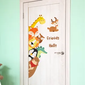 Cartoon giraffe and forest animals wall decals on a light wooden door in kids room