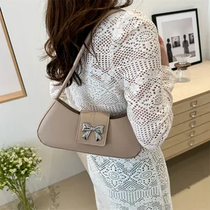 French style beige shoulder bag with silver butterfly buckle and minimalist design