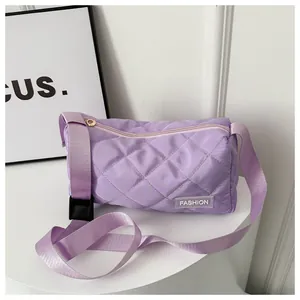 Detail of lavender quilted crossbody bag with diamond stitching and adjustable strap