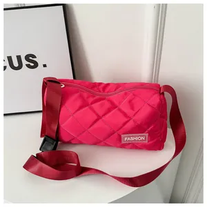 Detail of hot pink quilted shoulder bag with adjustable strap and fashion label tag