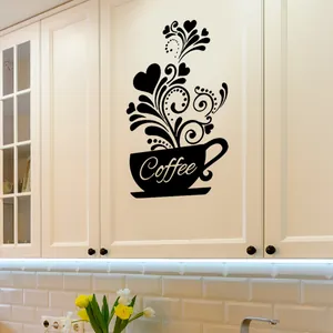 Detail of coffee cup wall sticker with vine patterns on a white kitchen cabinet door