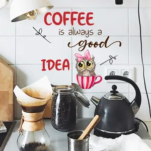 Detail of coffee wall decal with owl motif and text on white kitchen tiles