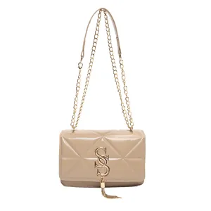 Fashionable beige quilted chain shoulder bag for women with gold tassel detail
