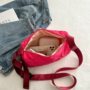 Chic magenta quilted rhombic crossbody bag with wide strap and spacious interior