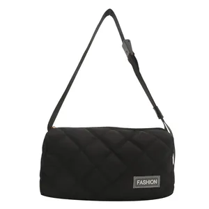 Black quilted crossbody bag with stylish lattice stitching and fashion label detail