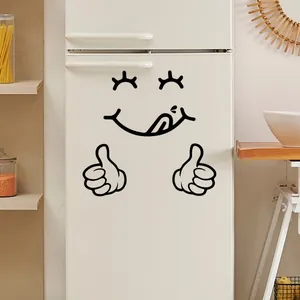 Funny smiling face wall sticker with thumbs up gesture on a white refrigerator surface