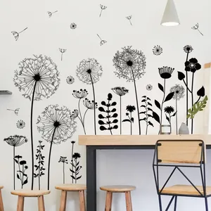 Detail of black dandelion wall stickers showing floral silhouettes in a modern living room