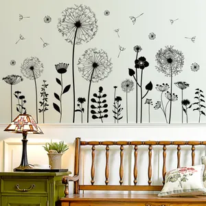 Detail of black dandelion wall stickers arranged on a beige wall above a nightstand