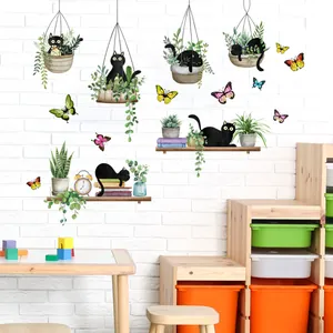Decorative wall stickers with black cats, green plants, and colorful butterflies on white wall