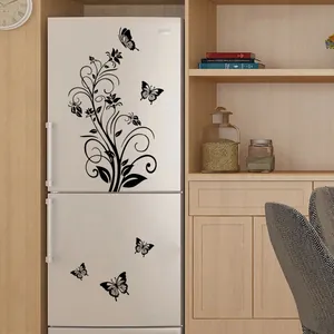 Detail of black floral vine and butterfly stickers on a white refrigerator door