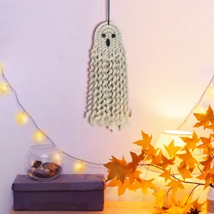 Macro shot of handmade woven macrame ghost decor with fringe details for Halloween