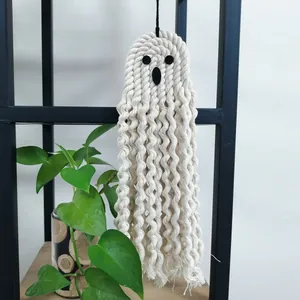 Detail of handcrafted macramé Halloween ghost wall hanging with cotton rope textures