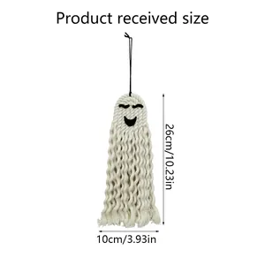 Macro detail of hand-woven Halloween ghost decor with size specs 26cm by 10cm