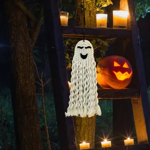 Close-up of handmade macrame ghost hanging with a smiling face for Halloween decor