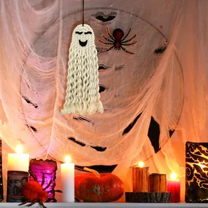 Detail of handmade woven white ghost wall hanging with cotton rope textures for Halloween