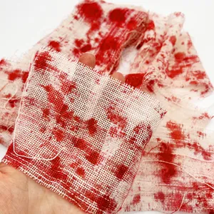Close-up of Halloween bloody white gauze featuring realistic red blood splatter and mesh texture