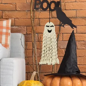 Detail of handmade woven white ghost wall hanging with cotton macrame fringe and texture