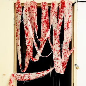 Detail of tattered white gauze with realistic red blood splatters for Halloween decor