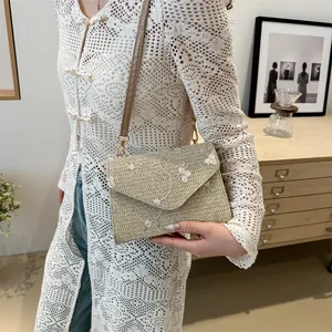 Woven straw crossbody bag for women with floral embroidery and brown leather strap