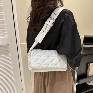 Modern white quilted shoulder bag with adjustable wide strap shown in a stylish side view