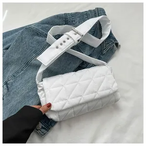 Close-up of white quilted oxford crossbody bag with adjustable silver buckle strap