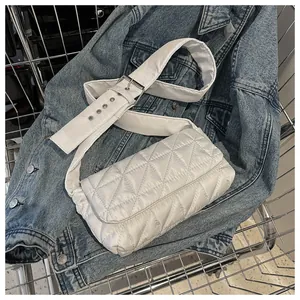 Detail of white quilted nylon crossbody bag with wide adjustable strap and silver buckles