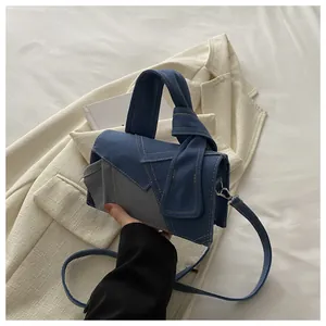 Détail du sac bandoulière en patchwork de denim avec coutures et poignée à nœud