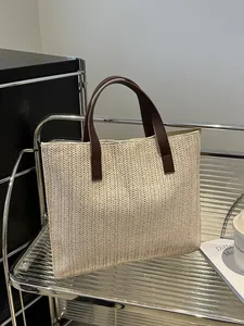 Macro detail of beige woven tote bag showing premium V-shaped texture and leather handles