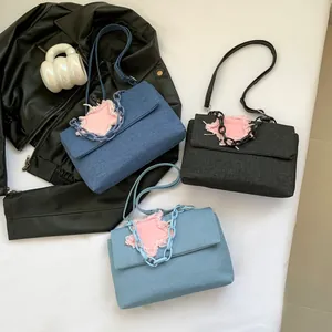 Denim flap crossbody bag with star patch and chunky chain in three vintage washes