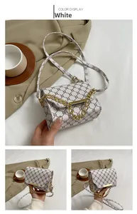 Detailed view of a vintage monogram cross-body bag with golden chain and white leather trim