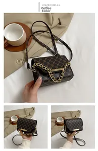 Detail view of coffee brown crossbody bag with vintage monogram and gold chain strap