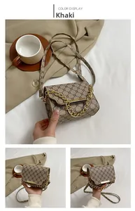 Detail of khaki vintage square bag with metal chain strap and monogram pattern