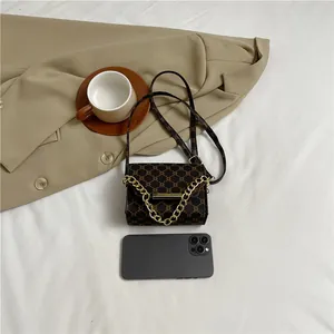 Vintage brown monogram crossbody bag with gold chain and phone for size reference