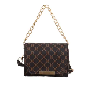 Vintage brown chain-print crossbody bag with chunky gold chain handle and leather strap