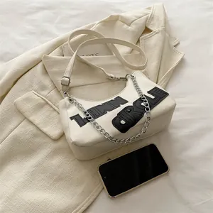 Chic beige crescent tote bag with LINN CIRCLE lettering and elegant silver chain