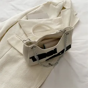 Cream white contrast tote bag with bold black letters and silver chain strap details