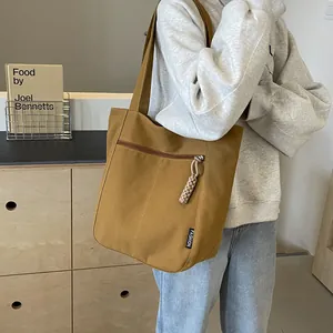 Canvas large capacity tote bag in mustard yellow with rope zipper and shoulder strap