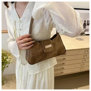 Detail of vintage brown matte shoulder bag with magnetic flap and metal buckle
