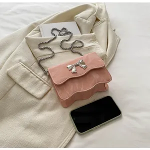 Detailed macro view of pink marble pattern bag with silver bow buckle and wave bottom edge