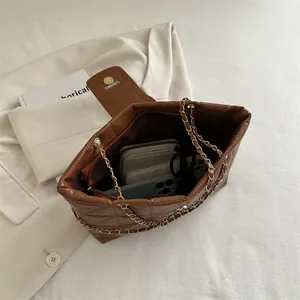Quilted brown chain shoulder bag with spacious interior for essentials and phone
