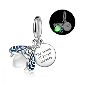 Luminous firefly charm pendant in silver and blue enamel with glowing effect detail