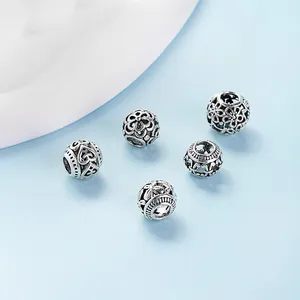 Set of 5 vintage hollow silver spacer beads with floral and heart patterns for DIY jewelry