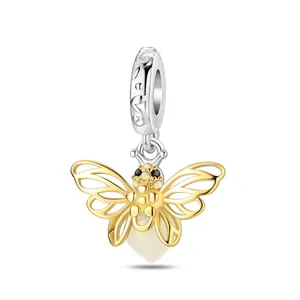 Detailed view of silver charm loop with LOVE engraving and golden bee pendant