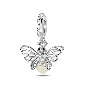 Intricate silver butterfly charm with hollow wing patterns and white heart pendant