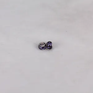 Macro shot of 14mm S925 purple flower resin beads with intricate floral patterns