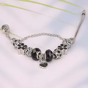 Silver snake chain bracelet with black floral beads and heart pendant charm