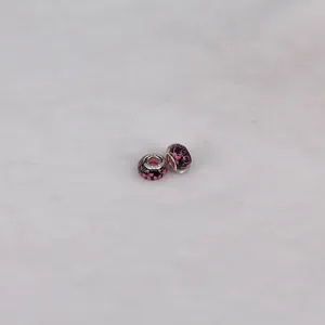 Macro shot of 14mm black floral resin beads with S925 sterling silver cores for DIY jewelry