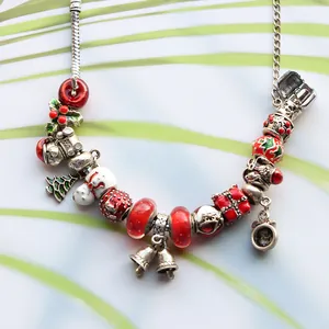Christmas themed beaded charm bracelet with Santa, tree, and bell pendants for women