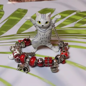 S925 sterling silver Christmas charm bracelet with snowman and bell charms on palm leaf